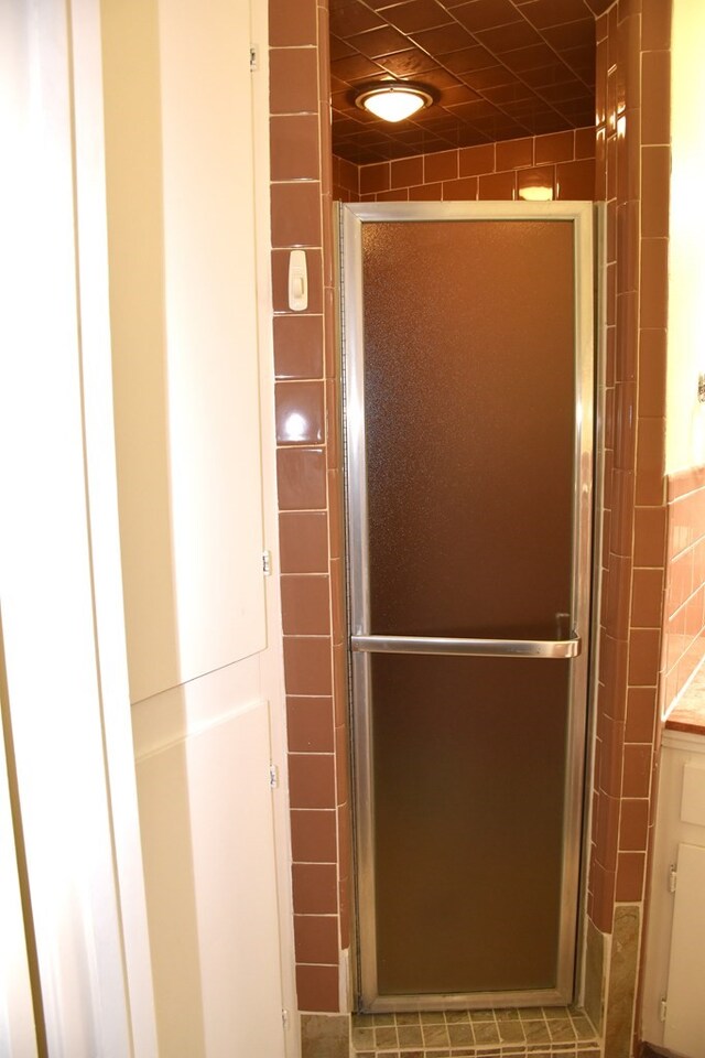 full bathroom with a shower stall and vanity