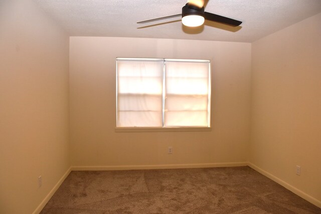 unfurnished room featuring a textured ceiling, carpet flooring, baseboards, and ceiling fan