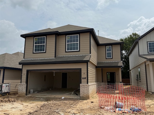 2103 Oakwood Terrace Dr, Houston, TX 77090 - view of front of house featuring an attached garage, a shingled roof, and brick siding