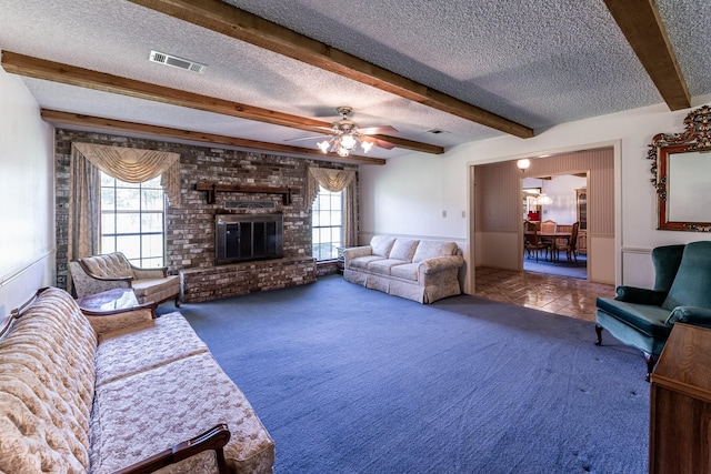 carpeted living area featuring a textured ceiling, visible vents, plenty of natural light, and beamed ceiling