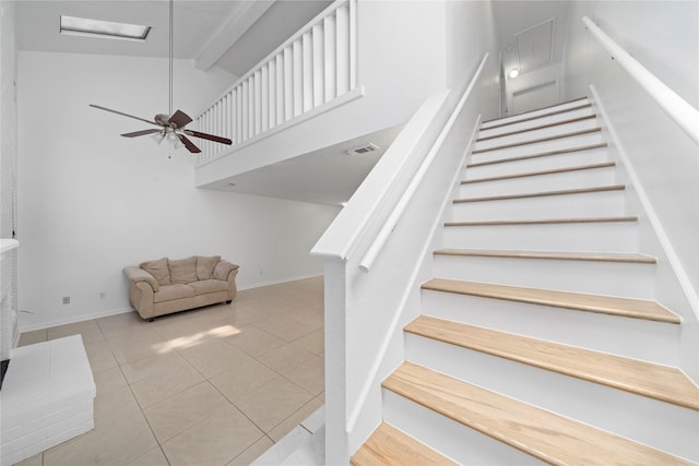 13742 Hollowgreen Dr Unit 604, Houston, TX 77082 - staircase with tile patterned floors, baseboards, a ceiling fan, beam ceiling, and high vaulted ceiling