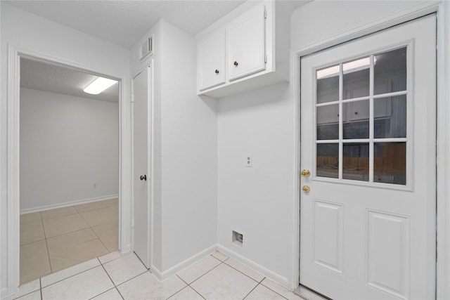 13742 Hollowgreen Dr Unit 604, Houston, TX 77082 - clothes washing area featuring light tile patterned floors, baseboards, and a textured ceiling