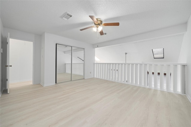 13742 Hollowgreen Dr Unit 604, Houston, TX 77082 - unfurnished bedroom with wood finished floors, a textured ceiling, ceiling fan, a closet, and baseboards