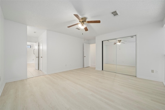 13742 Hollowgreen Dr Unit 604, Houston, TX 77082 - unfurnished bedroom with light wood-style flooring, ceiling fan, baseboards, connected bathroom, and a closet