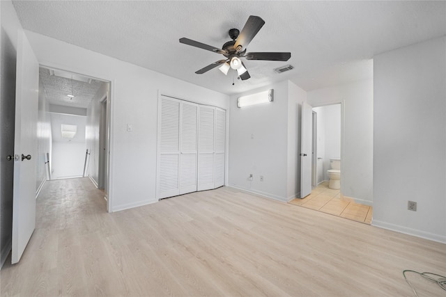 13742 Hollowgreen Dr Unit 604, Houston, TX 77082 - unfurnished bedroom with light wood-style floors, a textured ceiling, a closet, and baseboards