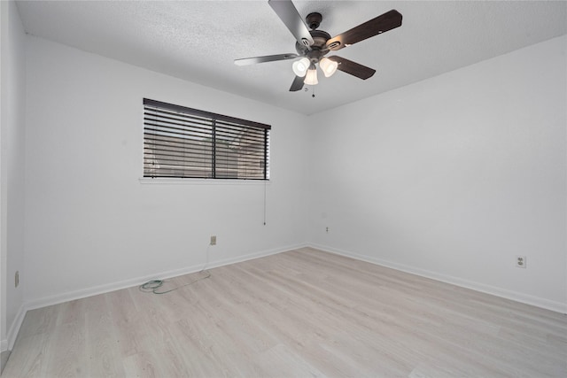 13742 Hollowgreen Dr Unit 604, Houston, TX 77082 - empty room with light wood-type flooring, ceiling fan, a textured ceiling, and baseboards