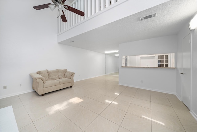 13742 Hollowgreen Dr Unit 604, Houston, TX 77082 - unfurnished living room with ceiling fan, tile patterned flooring, baseboards, and a textured ceiling