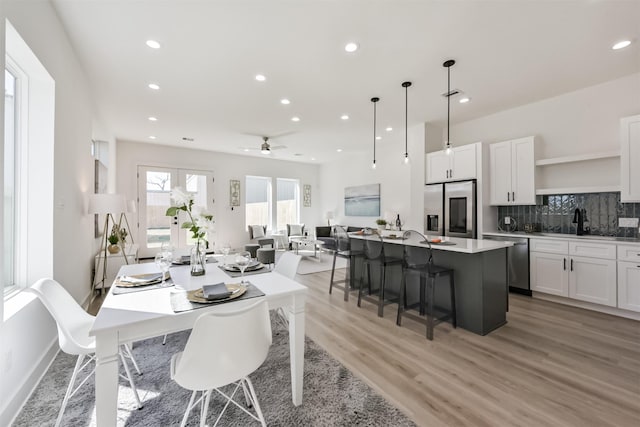 dining room featuring recessed lighting, a ceiling fan, and light wood-style floors