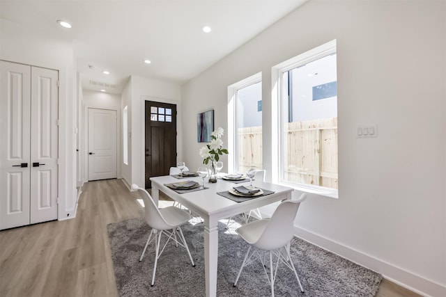 dining area featuring light wood-type flooring, recessed lighting, baseboards, and visible vents