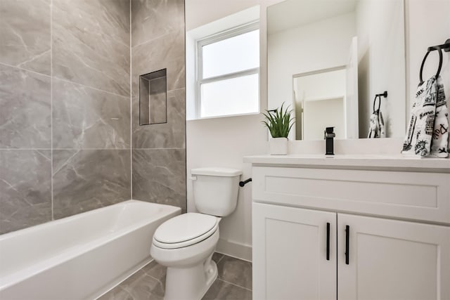 full bathroom featuring toilet, baseboards, bathing tub / shower combination, and vanity