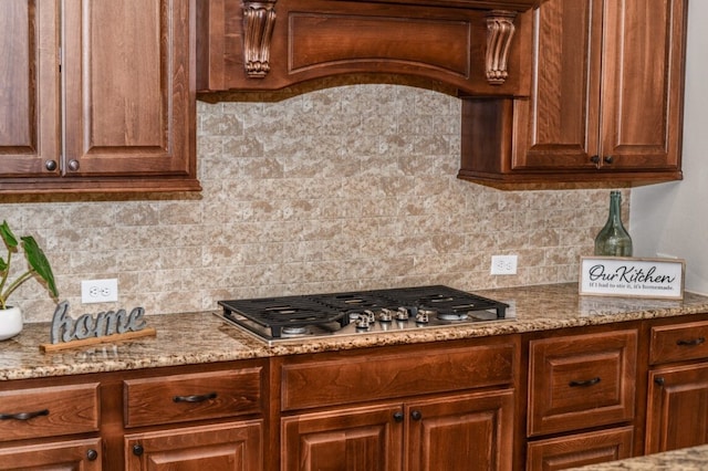 13819 Laurel Colony Trl, Houston, TX 77059 - kitchen with backsplash, light stone countertops, and stainless steel gas stovetop