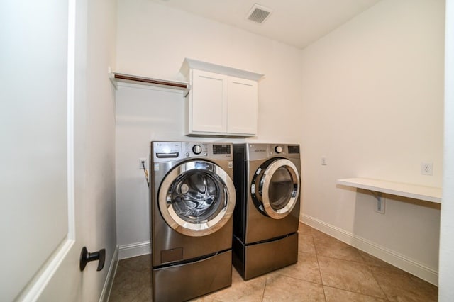 13819 Laurel Colony Trl, Houston, TX 77059 - clothes washing area with washing machine and clothes dryer, light tile patterned flooring, cabinet space, baseboards, and visible vents