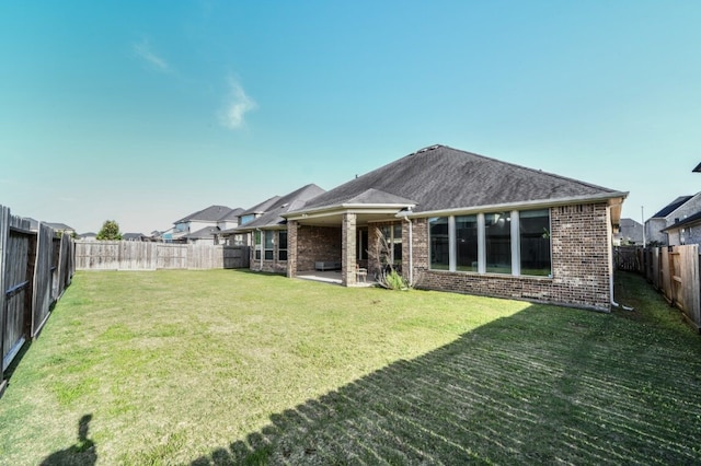 13819 Laurel Colony Trl, Houston, TX 77059 - rear view of house featuring brick siding, a yard, a patio area, and a fenced backyard