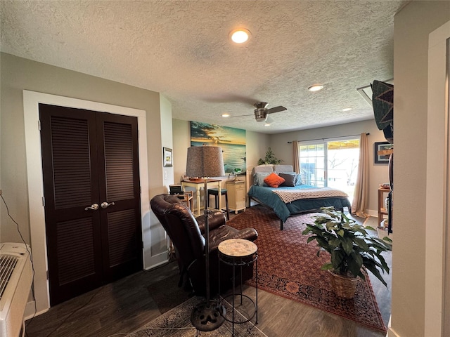 bedroom featuring a closet, wood finished floors, a textured ceiling, recessed lighting, and a ceiling fan