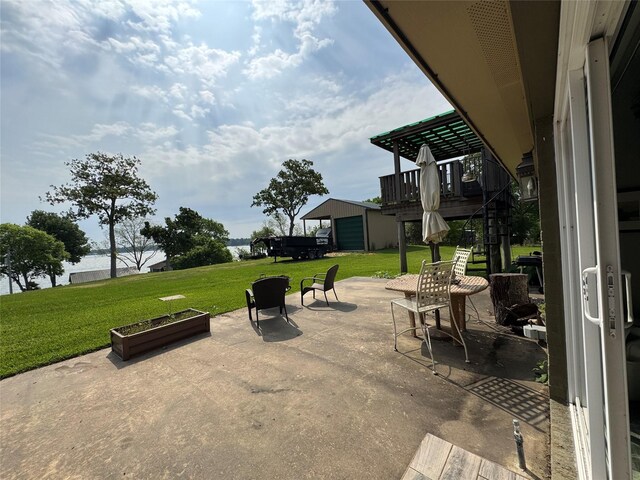 view of patio / terrace featuring a garage and stairs