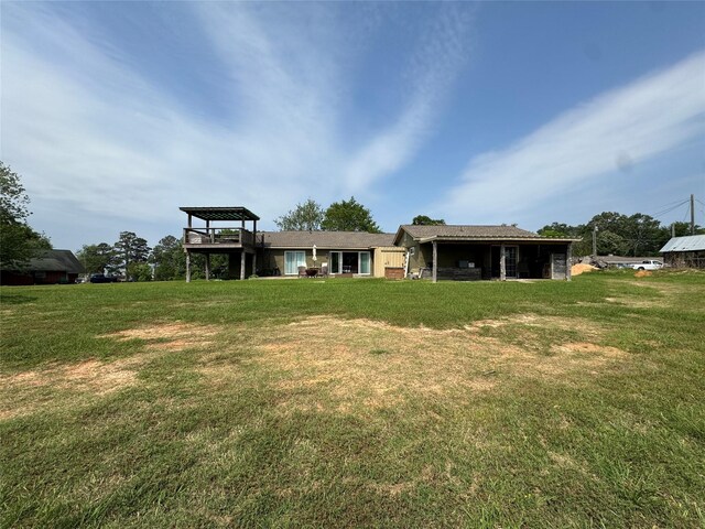 rear view of property with a lawn
