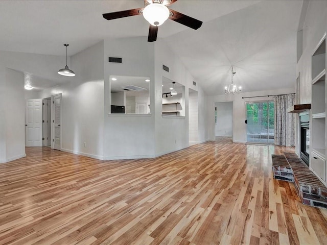 unfurnished living room with wood finished floors, ceiling fan with notable chandelier, a brick fireplace, visible vents, and high vaulted ceiling