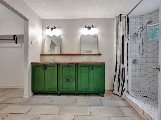 bathroom featuring a textured ceiling, a shower stall, and a sink