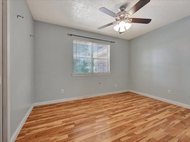 unfurnished room with baseboards, light wood-type flooring, a ceiling fan, and a textured ceiling