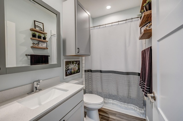 14302 Winema View Ln, Conroe, TX 77384 - full bath featuring vanity, toilet, wood finished floors, curtained shower, and recessed lighting