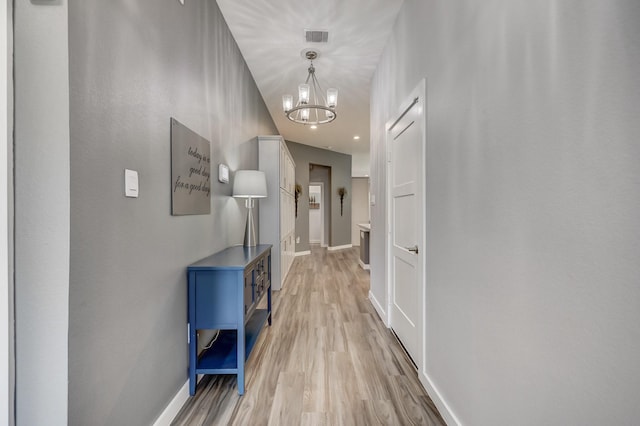 14302 Winema View Ln, Conroe, TX 77384 - hall featuring light wood-style flooring, baseboards, and a chandelier