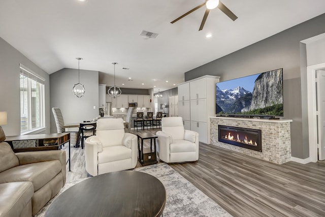14302 Winema View Ln, Conroe, TX 77384 - living room featuring ceiling fan, wood finished floors, a glass covered fireplace, recessed lighting, and vaulted ceiling