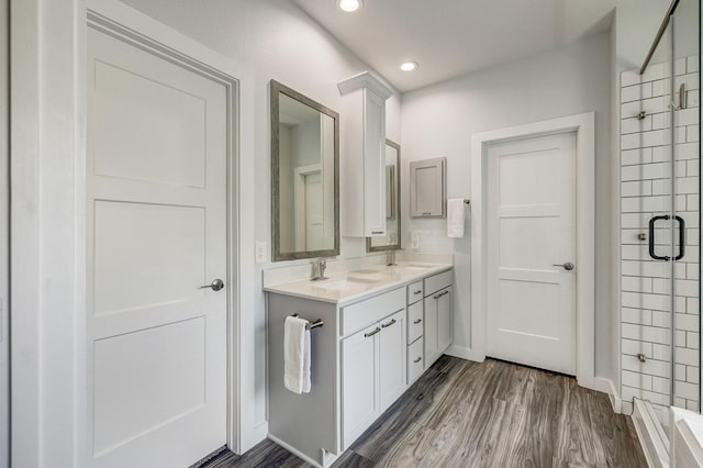 14302 Winema View Ln, Conroe, TX 77384 - full bathroom with a shower stall, double vanity, recessed lighting, wood finished floors, and baseboards