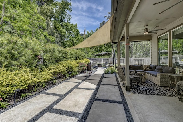 14302 Winema View Ln, Conroe, TX 77384 - fenced backyard with an outdoor hangout area, a patio area, and ceiling fan