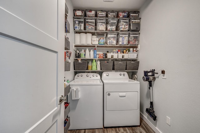 14302 Winema View Ln, Conroe, TX 77384 - laundry area featuring washer and dryer, wood finished floors, and baseboards