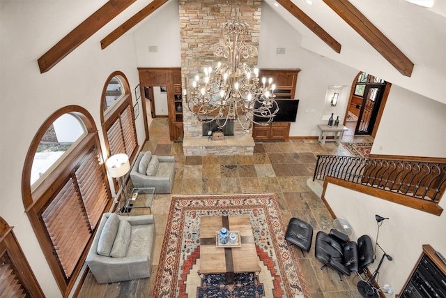 entrance foyer featuring beamed ceiling, high vaulted ceiling, a notable chandelier, and baseboards