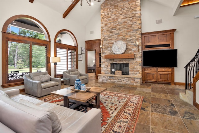 living room featuring stone tile floors, stairs, a fireplace, baseboards, and high vaulted ceiling