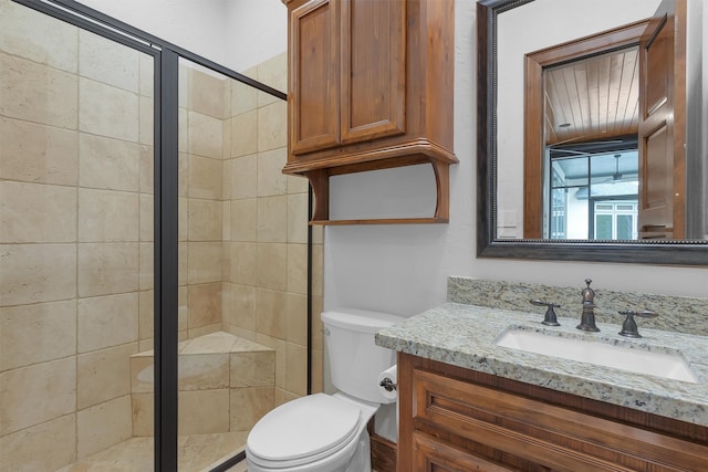 bathroom with vanity, toilet, and a stall shower