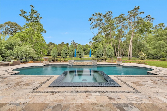 view of swimming pool featuring a patio, a pool with connected hot tub, and fence