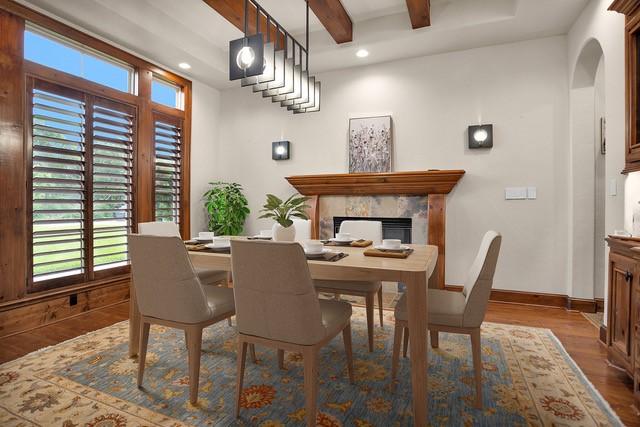 dining space featuring a premium fireplace, arched walkways, baseboards, wood finished floors, and beamed ceiling