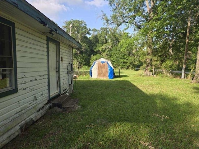 view of yard with an outbuilding and a storage shed