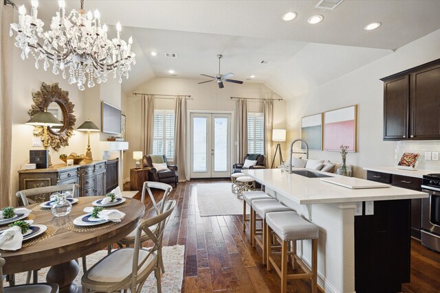 kitchen featuring dark wood finished floors, dark brown cabinetry, open floor plan, and a sink