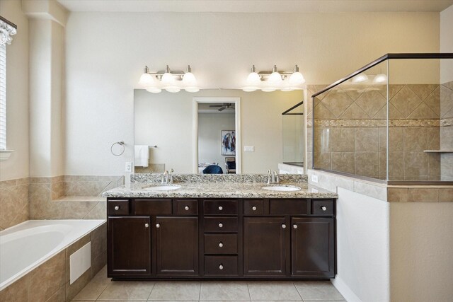 ensuite bathroom featuring a tile shower, a bath, ensuite bathroom, and a sink