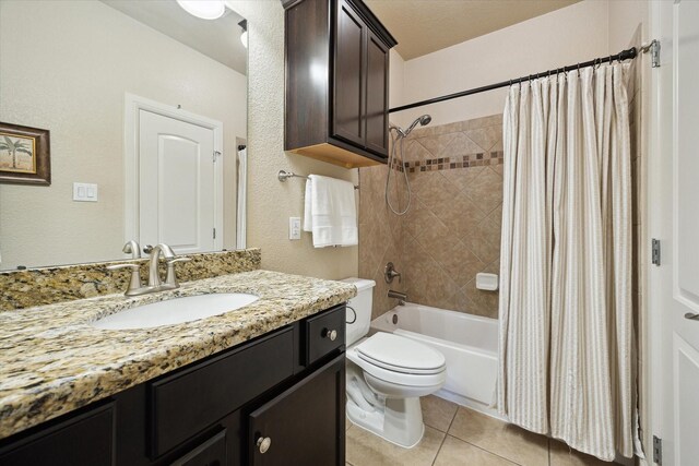 full bath with tile patterned floors, vanity, shower / bathtub combination with curtain, and toilet