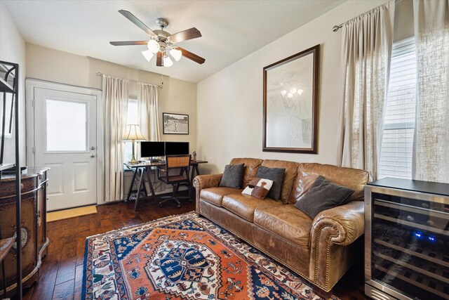 living area featuring dark wood-style floors, ceiling fan, and wine cooler
