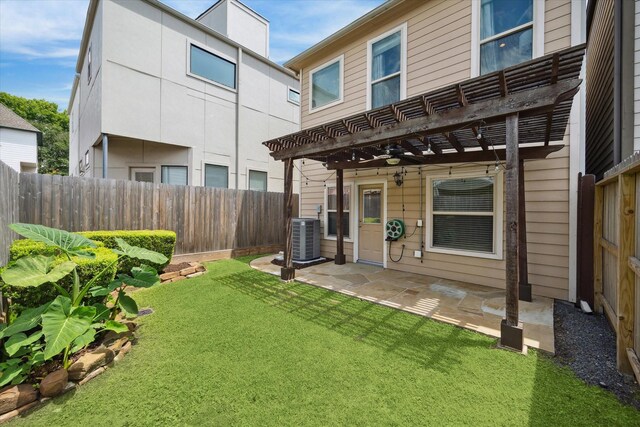 rear view of house featuring a pergola, a fenced backyard, a yard, central air condition unit, and a patio area