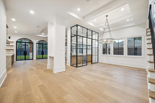 interior space with recessed lighting, wood finished floors, and a notable chandelier