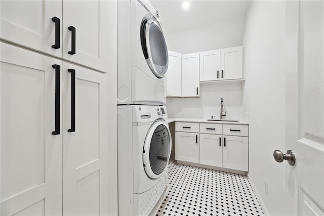 701 Coronado St, Houston, TX 77009 - washroom with stacked washer / dryer and cabinet space