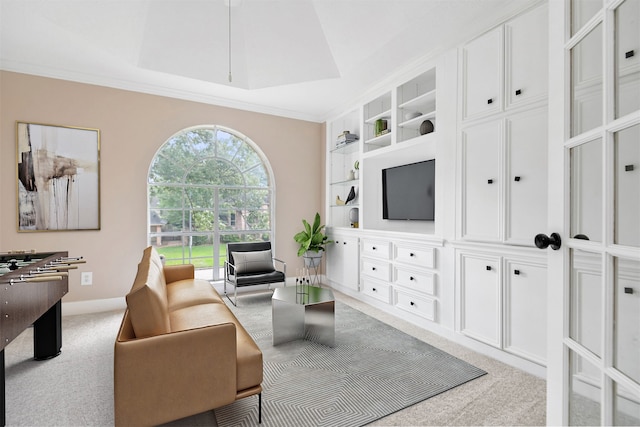 carpeted living room featuring baseboards, ornamental molding, and built in features
