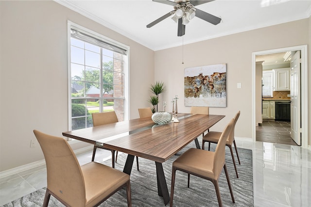 dining room with baseboards, ornamental molding, and ceiling fan