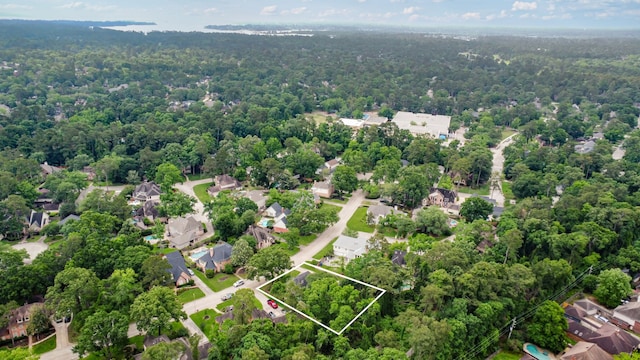 drone / aerial view featuring a residential view and a forest view