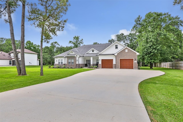 8118 S Laura Cir, Baytown, TX 77521 - craftsman house with a front yard, brick siding, and a garage