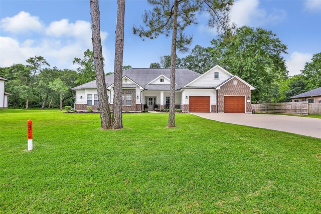 8118 S Laura Cir, Baytown, TX 77521 - view of front of property with fence, an attached garage, brick siding, concrete driveway, and a front yard