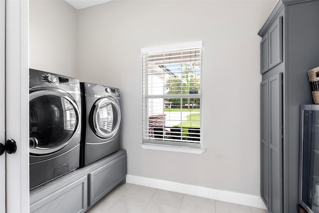8118 S Laura Cir, Baytown, TX 77521 - laundry area featuring washer and clothes dryer, cabinet space, baseboards, and light tile patterned floors