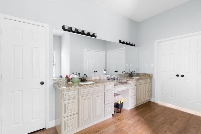 8118 S Laura Cir, Baytown, TX 77521 - full bathroom featuring double vanity, a sink, and wood finished floors