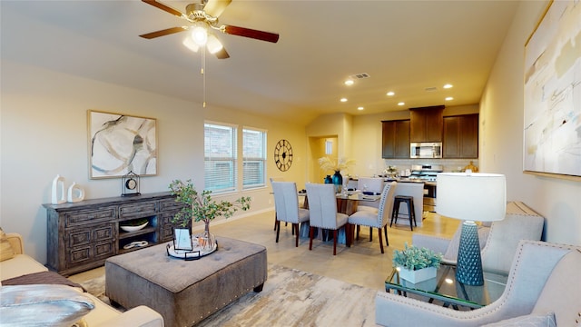 living area with visible vents, a ceiling fan, baseboards, and recessed lighting
